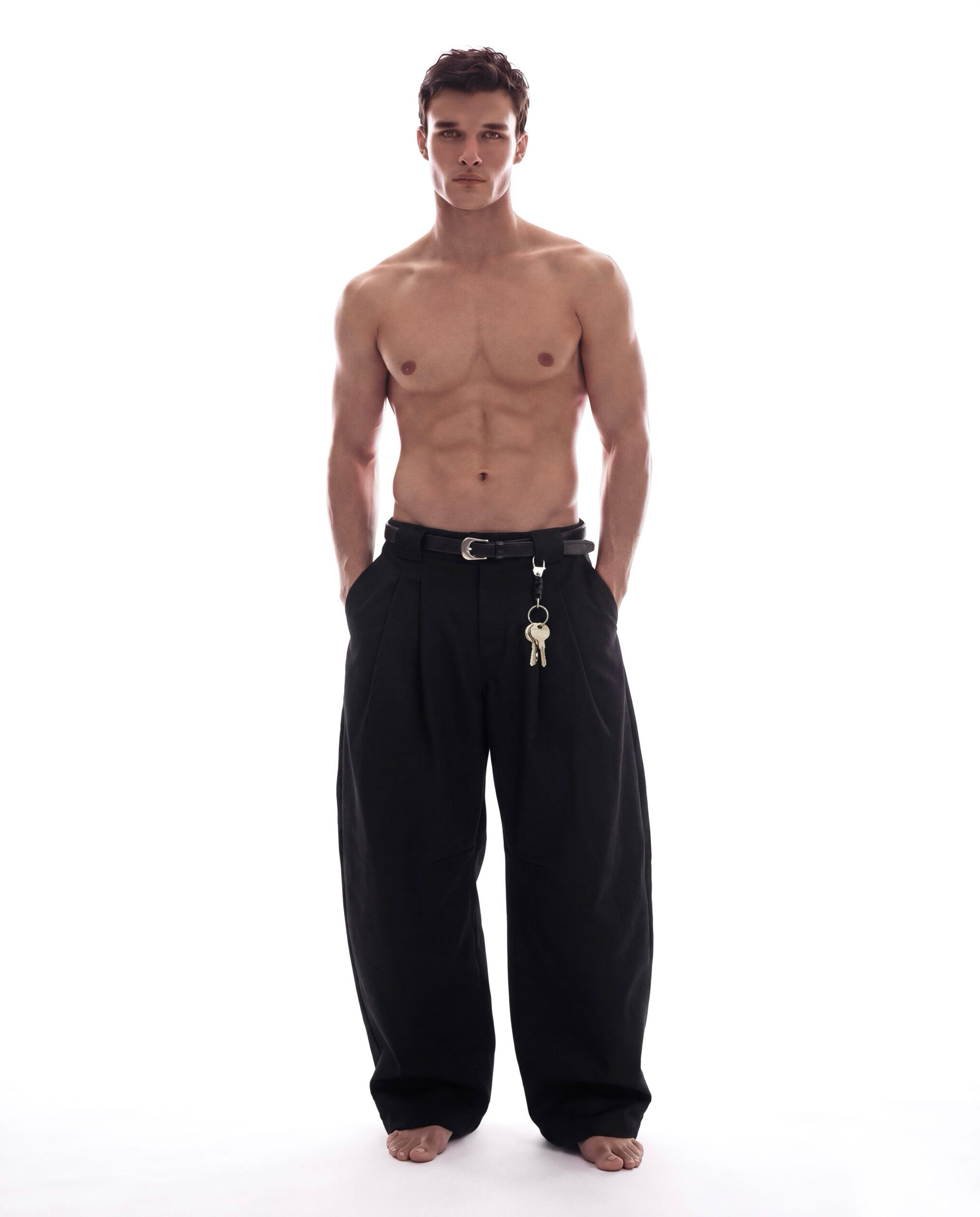 Unisex black wide-leg pants with belt and keychain accessory.