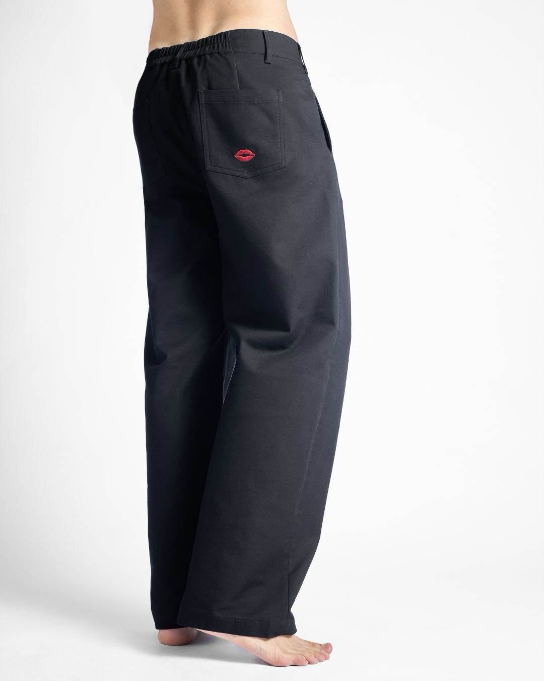 Unisex black pants with red lips embroidery, casual style for men and women.